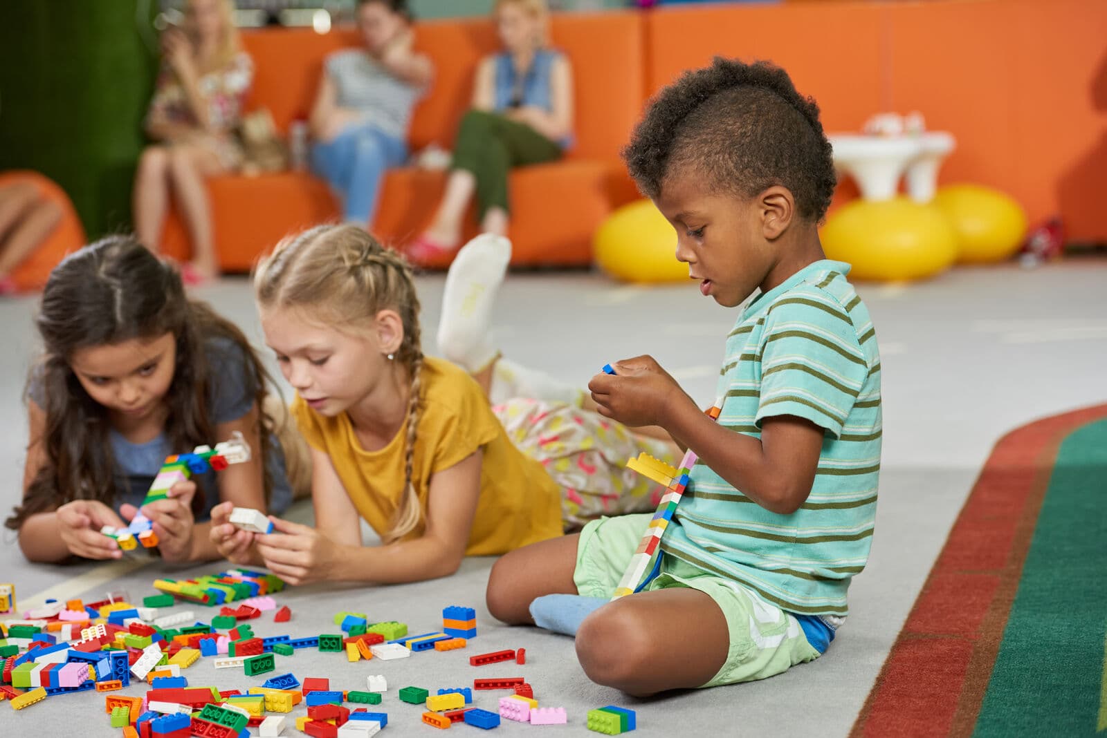 Children building with colorful blocks indoors